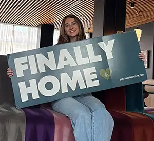 girl holding finally home sign